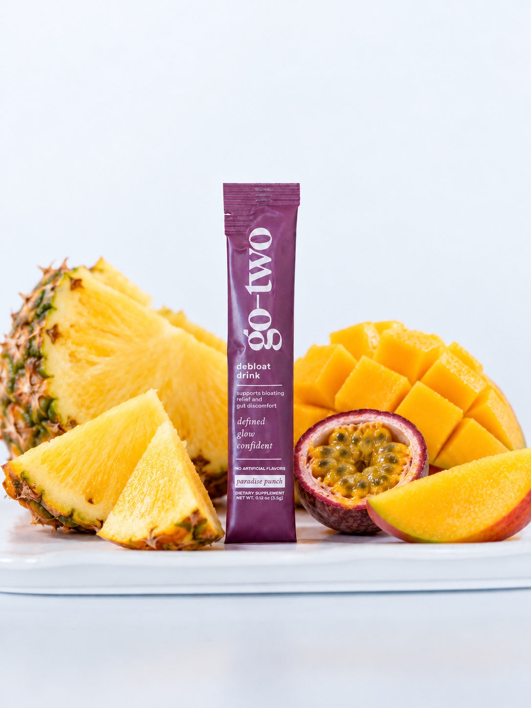 Paradise Punch Debloat product image with a purple stick pack and fruit