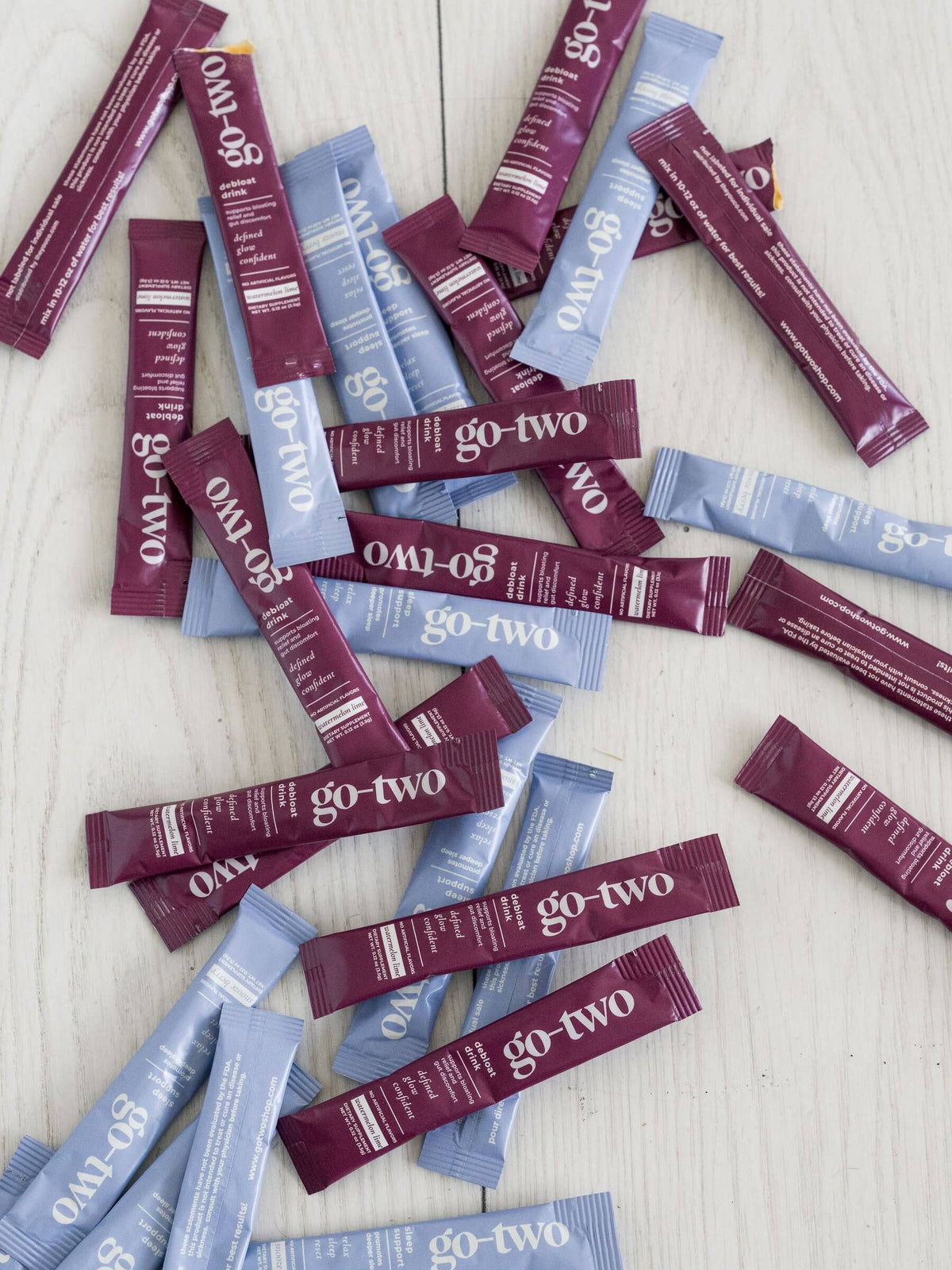 Go-Two Debloat and Sleep Support sticks arranged on a wood table